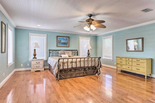 a bedroom with a bed and a ceiling fan at Spacious Gulf Shores Hideaway with Pool and Deck! in Gulf Shores