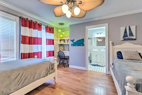 a bedroom with a bed and a ceiling fan at Spacious Gulf Shores Home Private Pool and Deck! in Gulf Shores