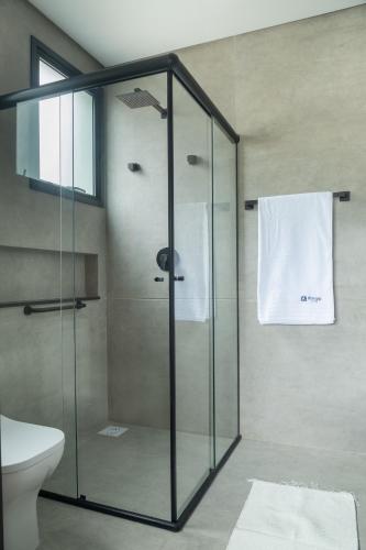 a glass shower stall in a bathroom with a toilet at Hospedaria da Lagoa in Florianópolis