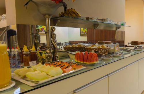 a buffet line with different types of food on display at Hotel Cidade Araxá in Araxá