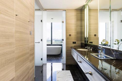 a bathroom with two sinks and a bath tub at St Regis Luxury 3 Bedroomm in Kuala Lumpur