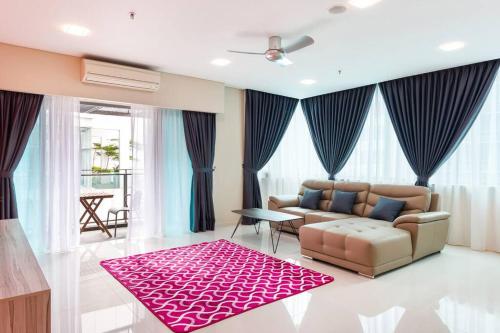 a living room with a couch and a red rug at Bright 2BR Condo for 6 I KL City View in Kuala Lumpur