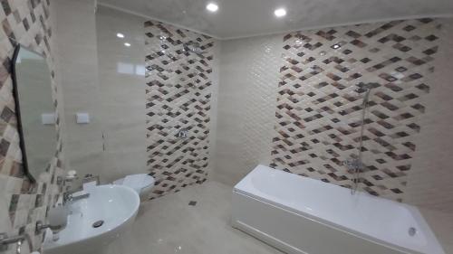 a bathroom with a toilet and a sink and a shower at Hotel Dream in Stara Zagora