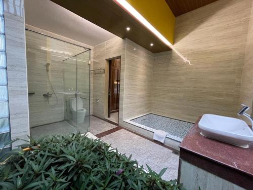 a bathroom with a shower and a sink and a toilet at Cahaya Villa Garut in Garut