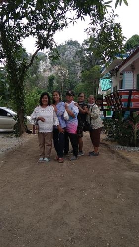 a group of people posing for a picture at ชายเขาโฮมสเตย์ in Kanchanaburi
