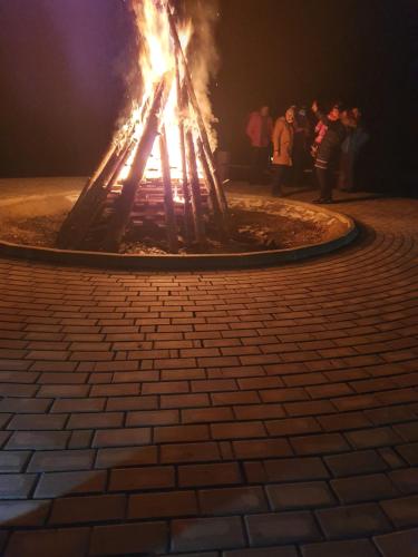 a fire pit in the middle of a brick sidewalk at Monte Cervo Bio Hotel & Spa in Covasna