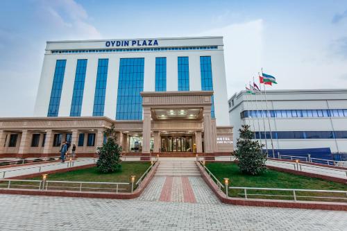 a building with a sign that reads oxyán plaza at OydinPlaza Hotel in Namangan