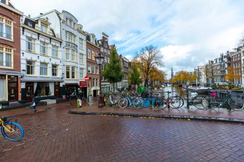 a group of bikes parked on a city street at Amsterdam Wiechmann Hotel in Amsterdam