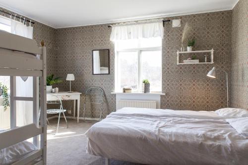 a bedroom with a bed and a desk and a window at Immeln Guest House in Immeln