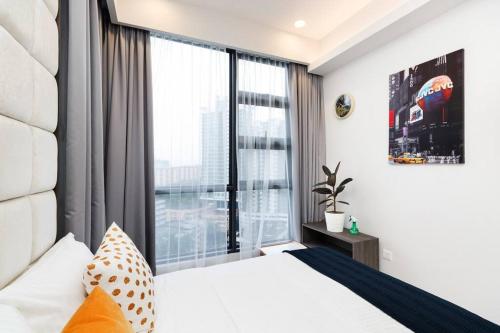 a bedroom with a bed and a large window at Urban hive in Bukit Bintang I Robertson Residence in Kuala Lumpur