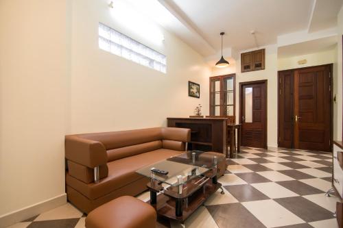 a living room with a couch and a table at Hai Duong Apartments 70 Van Kiep in Hanoi