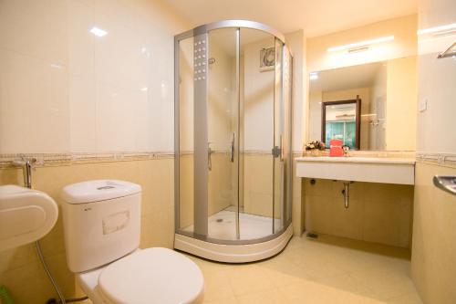 a bathroom with a shower and a toilet and a sink at Hai Duong Apartments 70 Van Kiep in Hanoi