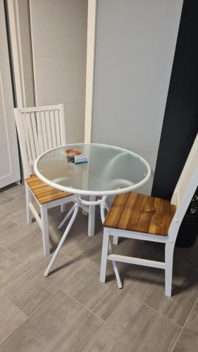 a white table and a bench and a table and chairs at Flensburg City - 24h in Flensburg
