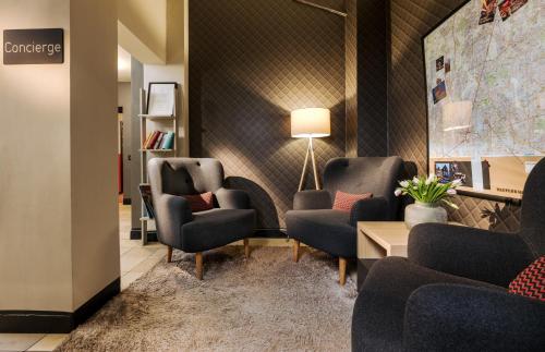 a waiting room with chairs and a map on the wall at Apartment040 in Hamburg