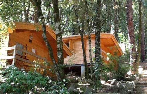 a wooden cabin in the middle of a forest at Auberge De La Foret Bonifatu in Calenzana
