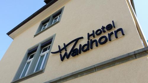 a sign on the side of a building at Hotel Waldhorn in Bern