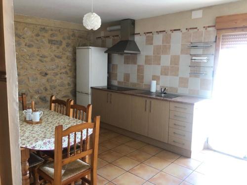 a kitchen with a table and a dining room at CASA RURAL LLAVADOR Vall Guadalest in Benifató