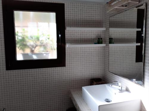 a bathroom with a sink and a mirror at CASA PIZZI in Agua Amarga