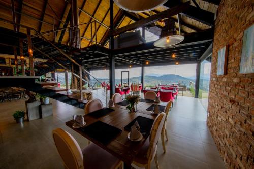 a dining room with a table and chairs with a view at The Plains Green in Ambawela