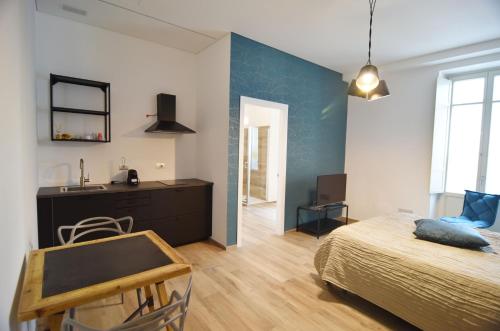 a bedroom with a bed and a desk at Roma 141 in Fossano