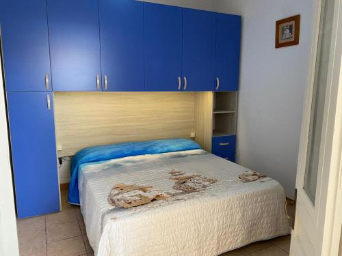 a bedroom with blue cabinets and a bed at Villa Camelia in Torre Lapillo