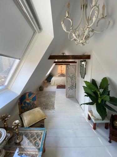 a hallway with a chandelier and a room with a bed at Casa Blanca Old City - Alkmaar in Alkmaar