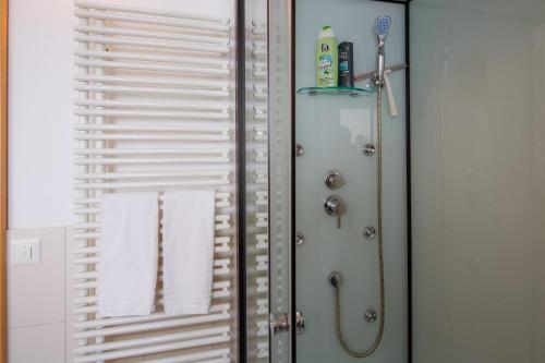 a bathroom with a shower with a towel at Modern and cosy 5 rooms penthouse with stunning view in Triesenberg