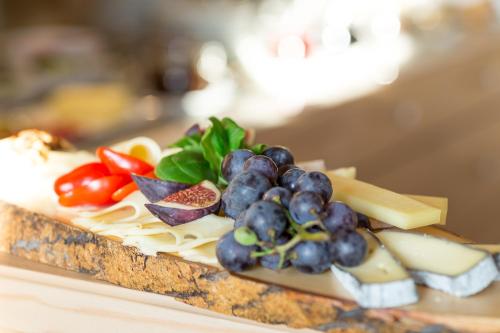 a plate of cheese and vegetables on a table at Landhotel Spreitzhofer in Sankt Kathrein am Offenegg