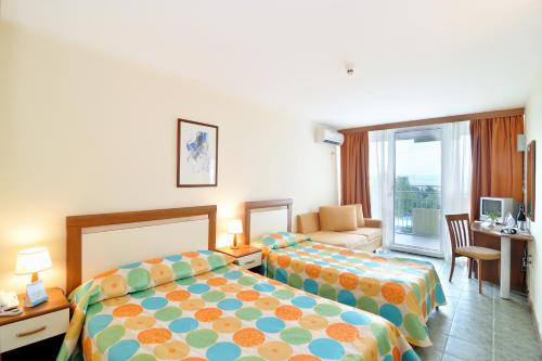 En eller flere senge i et værelse på Hotel Laguna Mare