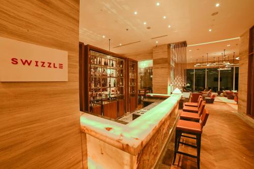 a bar in a hotel lobby with a long counter at Welcomhotel by ITC Hotels, Bhubaneswar in Bhubaneshwar