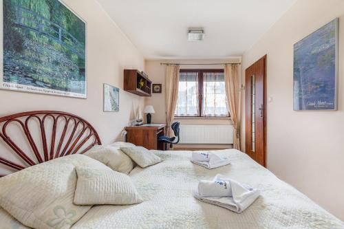 a bedroom with a bed with two towels on it at Apartamenty Żeromskiego 29 by Renters in Świnoujście