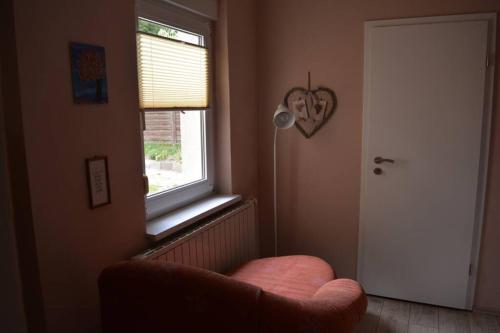 a living room with a chair and a window at Ferienhaus Hüthchen in Eichhorst