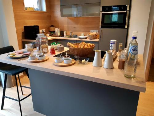 a kitchen with a table with food on it at B&B Caprice d'Epices in Francorchamps