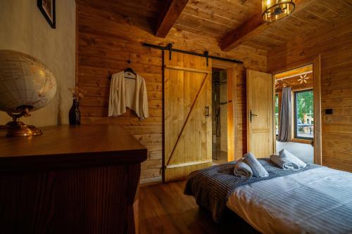 a bedroom with a bed and a desk in a cabin at Szałas "Jodłowe Izby" in Białka Tatrzanska