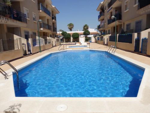 a swimming pool in the middle of a building at Nice apartment with spacious terrass and rooftop in Los Alcázares