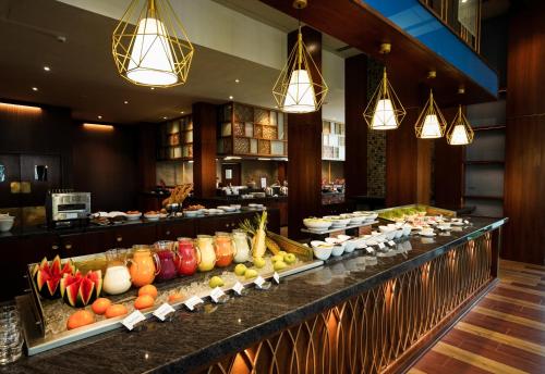 a buffet line in a hotel with fruits and vegetables at Rosetta Sakleshpur in Sakleshpur