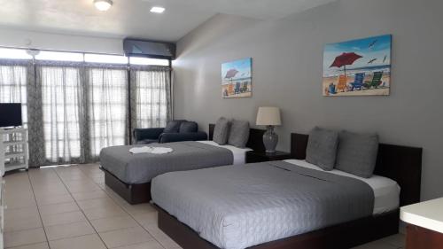 En eller flere senge i et værelse på Parador Villas Del Mar Hau
