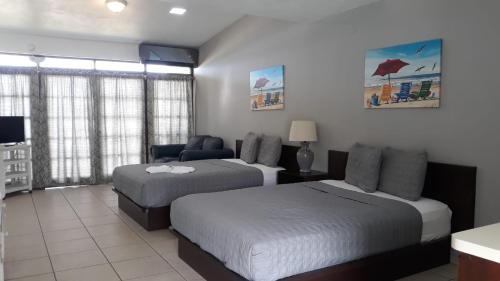Postel nebo postele na pokoji v ubytování Parador Villas Del Mar Hau