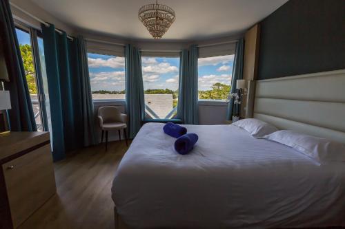 Un ou plusieurs lits dans un hébergement de l'établissement Le Diana Hôtel & Spa