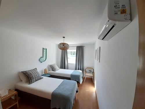 a hotel room with two beds and a couch at Doce Mar in Cabanas de Tavira