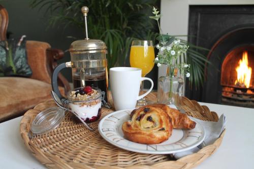 a basket with a plate of food on a table at stay bed and breakfast in Culross