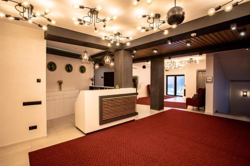 a large lobby with a red rug and a fireplace at Premium Club SPA in Bukovel