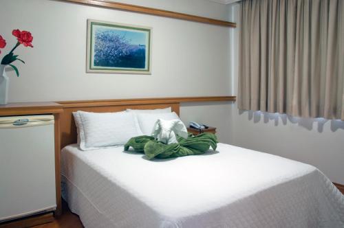 Cama ou camas em um quarto em Grande Hotel Guarapuava