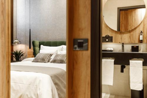 a hotel room with two beds and a mirror at SCHUSTER Boarding House in Braşov
