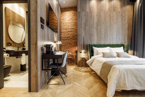 a bedroom with a bed and a table and a mirror at SCHUSTER Boarding House in Braşov