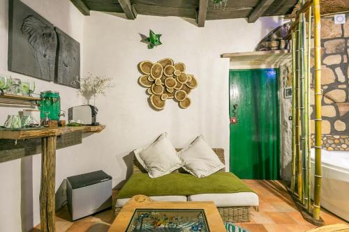 a room with a bed and a green shower at Opera Suites - Il sentiero della felicità in Calcata