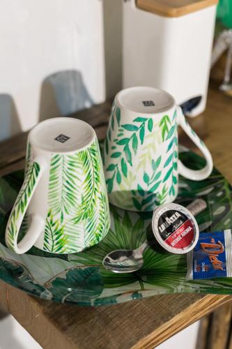 a table with two coffee mugs on a table at Opera Suites - Il sentiero della felicità in Calcata