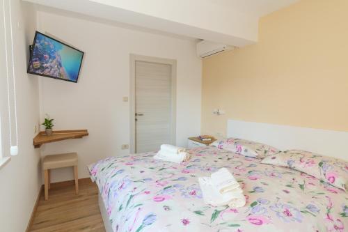 Postel nebo postele na pokoji v ubytování Apartmani Ravan
