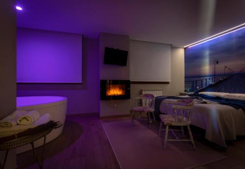 a purple room with a bed and a fireplace at Posada Valle de Güemes in Güemes