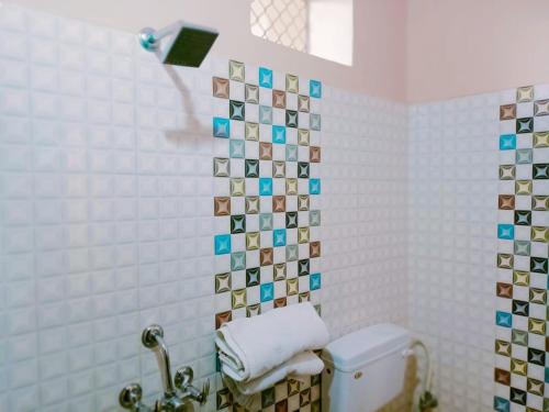 a bathroom with a toilet and a towel dispenser at Hotel marwari niwas in Haridwār